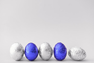 Sweet chocolate eggs on light background