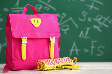 School backpack on table in classroom