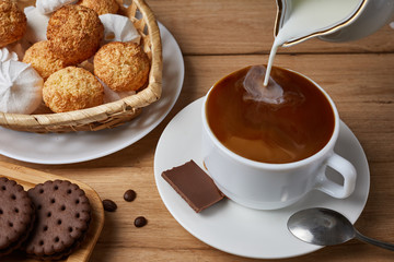breakfast with croissants.Fresh crispy croissants and coffee with milk on a blue background and wooden table