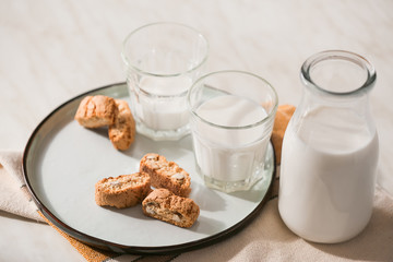 Glassware of fresh milk and cookies on table