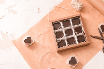 Box with delicious candies on white background