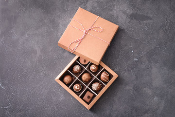 Box with delicious candies on dark background