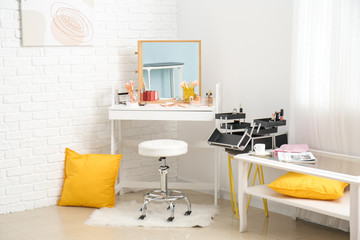 Fototapeta na wymiar Workplace of makeup artist in interior of modern beauty salon
