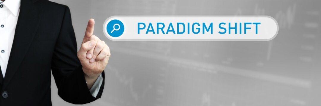 Paradigm Shift. Man in a suit points a finger at a search box. The word Paradigm Shift is in the search. Symbol for business, finance, statistics, analysis, economy