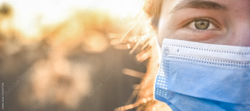 Wall mural Woman wearing protective mask against coronavirus. Put mask to fight against Corona virus. COVID-19 SARS, SARS-CoV, virus 2020 chinese virus 2019-nCoV