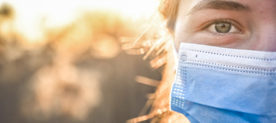 Woman wearing protective mask against coronavirus. Put mask to fight against Corona virus. COVID-19...