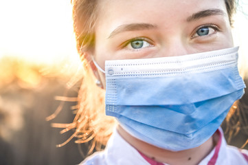 Woman wearing protective mask against coronavirus. Put mask to fight against Corona virus. COVID-19...