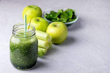 Glass Jar of Healthy Green Smoothie Detox Drink wirh Green Apple Celery and Raw Spinach Diet Beverage Ingredients For Smoorhie