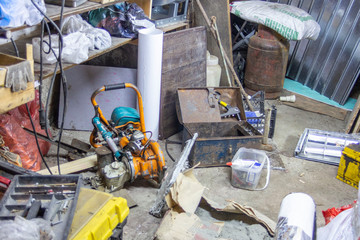 Big mess in an over stuffed suburban garage.