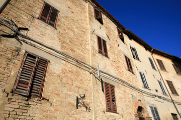 Fototapeta na wymiar Corinaldo (AN), Italy - January 1, 2019: View of an old facade in Corinaldo village, Corinaldo, Ancona, Marche, Italy
