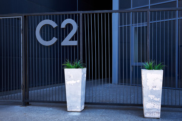 flower pot near the metal grate fence