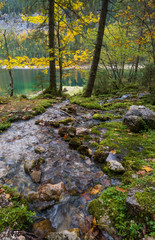 Peaceful autumn Alps mountain lake with clear transparent water and reflections. Gosauseen or Vorderer Gosausee lake, Upper Austria.