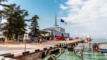 BATUMI, GEORGIA - MARCH 27, 2020: Sea port and tourists on a sunny day.