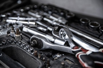 Dirty used wrench and tools in mechanic tool box