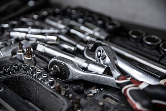 Dirty used wrench and tools in mechanic tool box