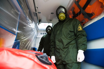 Coronavirus covid 19. The ambulance, equipped for the carriage of infected patients. Label: "Caution Biohazard" and a Biohazard sign.