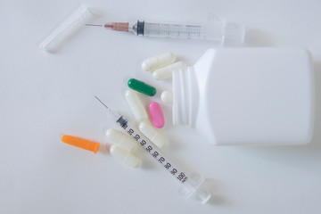 syringe and white pill bottle, Concept medicine and antibiotics, viral vaccine.