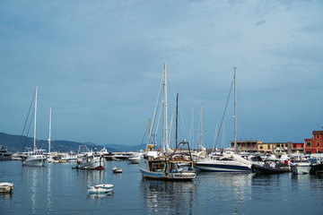 Naklejka na ściany i meble Wide panoramic view of luxury yachts and sailing boats moored in harbor of Santa Margherita Ligure, Italian Riviera. Beautiful mediterranean landscape with cloudy blue sky.