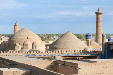 View at Itchan Kala (old or inner city), Tash Khauli palace (or Tosh Hovli, 19th century) and minaret of Sayid Niaz Sheliker Mosque. Khiva, Uzbekistan, Central Asia.