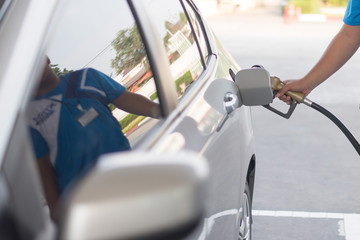 People use automobile refueling machines in petrol stations. Oil prices down a lot