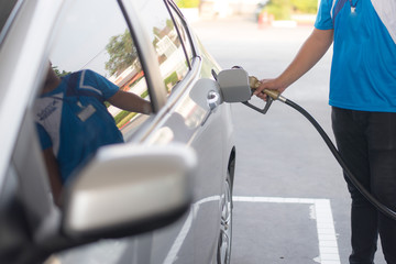 People use automobile refueling machines in petrol stations. Oil prices down a lot