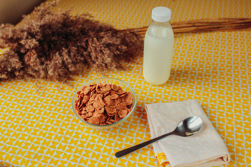 Cereals, spoon and milk bottle on the table. Healthy nutrition, healthy food on the table.