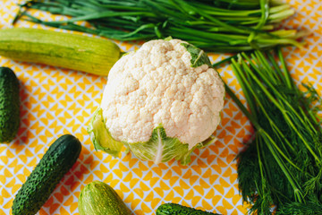 Healthy nutrition, healthy food on the table, greens and vegetables, cauliflower, cucumbers and...