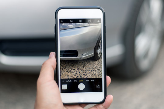 People using a phone to take pictures of cars that have signs of crash For the insurance company to assess the damage price