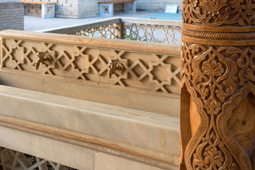 Inner courtyard with basin for ritual purification (ablution) and old wooden pillar. Pahlavon Mahmud mausoleum, Khiva, Uzbekistan, Central Asia.