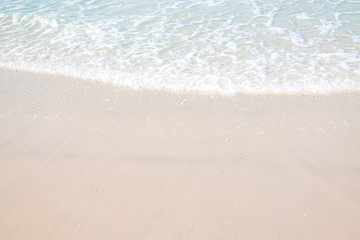 Ocean waves on the sandy beach for background, concept of the beach in the summer