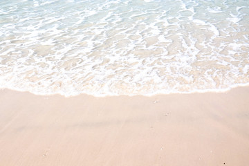 Ocean waves on the sandy beach for background, concept of the beach in the summer
