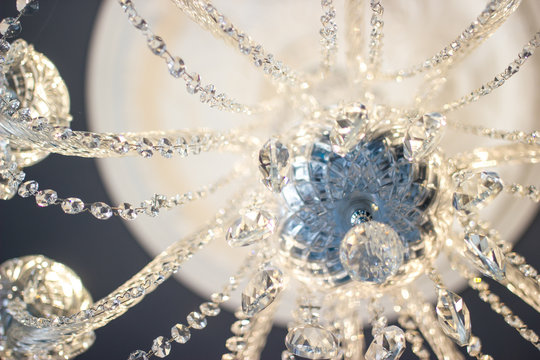 Horizontal detail image of a crystal chandelier.