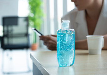 blue alcohol gel pump bottle for use in hand washing placed on table in workplace or hospital, prevent germs protect from coronavirus or covid-19 virus world pandemic,health care and medicine concept