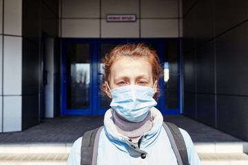 Woman wearing hygienic mask to prevent the Coronavirus.People in masks The outbreak of Novel Corona virus (2019-nCoV) in Europe.Concept of coronavirus quarantine.Girl in a  medical mask in quarantine