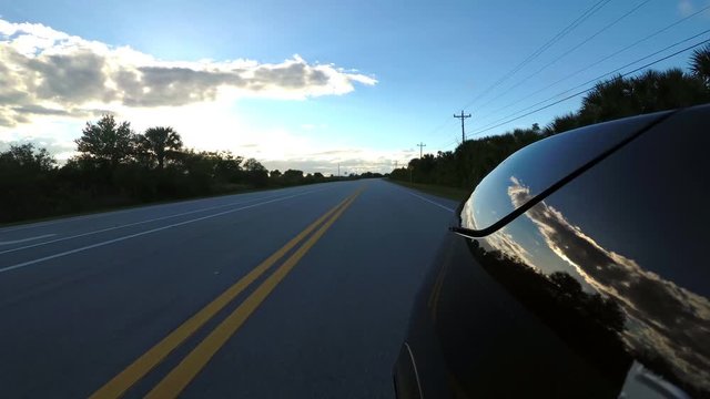 Driving down a road through the Everglades - Florida Road - first person view