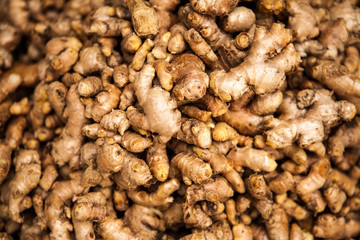 Fresh Ginger Roots on a counter in the market. Selective focus