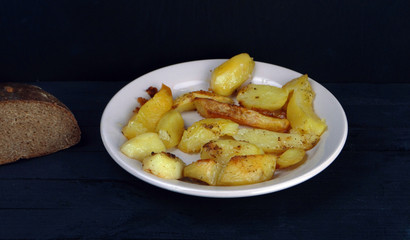  a plate of fried fresh potatoes is on the table