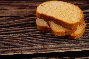 Fresh wheat toast on a wooden background. Close up.