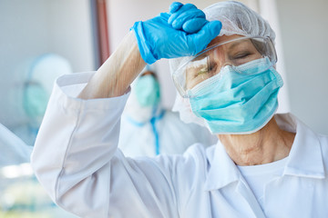 Overworked female doctor with burnout in Covid-19 epidemic
