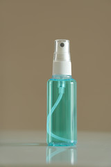 bottle of spray alcohol on brown background