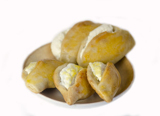 fresh pastries with a filling on a plate on a white background
