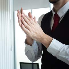 Caucasian business man in office using alcohol gel and rubbing hands back and forth to kill virus....