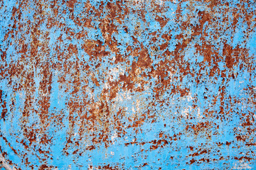 Rusty sheet of metal with peeling blue paint. Abstract industrial background.