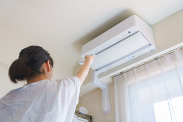 エアコン　温度調節　換気　冷房　夏　リモコン　リビング　人物　女性　日本人　ウィルス対策　空気清浄機