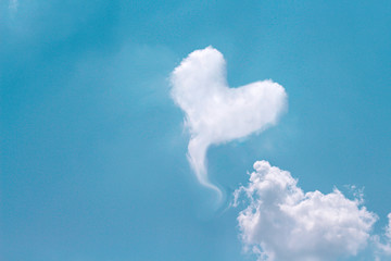 Bright blue sky background with  clouds in heart shaped patterns  , copy space