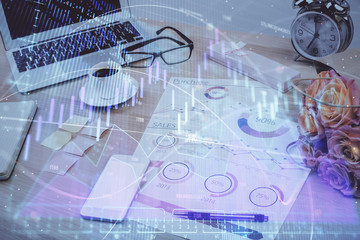 Forex market graph hologram and personal computer on background. Double exposure. Concept of investment.