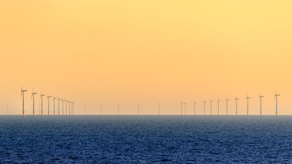 HORNSEA OFFSHORE WIND FARM, UK - 2016 JULY 15. Wind turbines of the Hornsea Offshore Wind Farm, offshore windfarm off the UK coast in the North Sea at sunset.