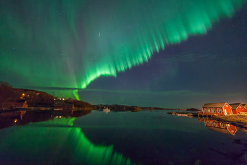 ULSTEINVIK, NORWAY - 2016 MARCH 06. Northern lights - Aurora borealis over harbor of Dimna.