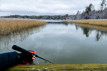Obraz na płótnie Canvas Winter fishing. Man's hand and fishing rod.