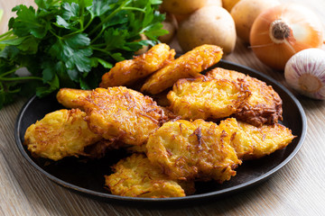Fried potato pancakes with fresh vegetables and herbs. Ukrainian and Belorussian national cuisine